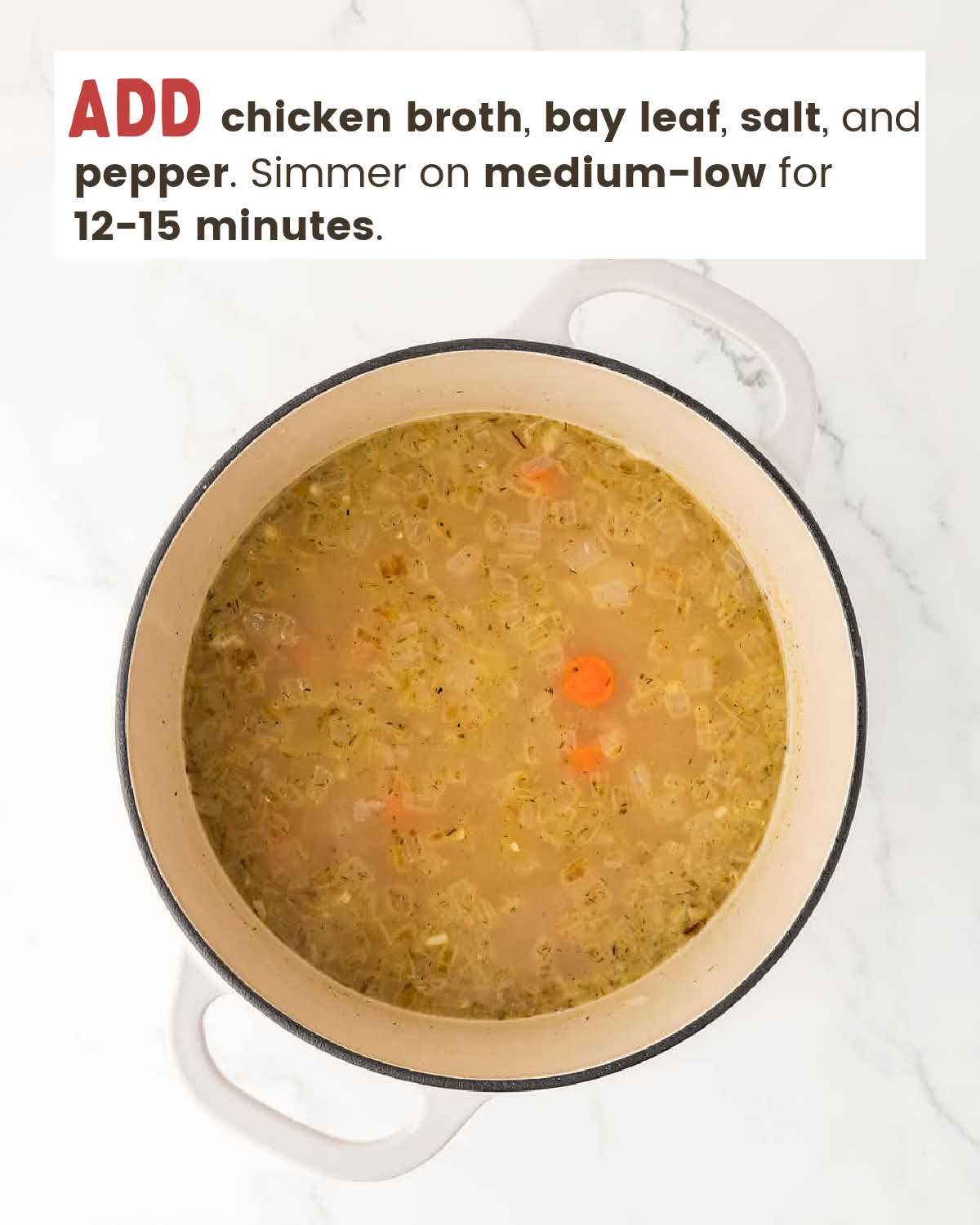 Chicken broth with carrots and onions in a large pot.