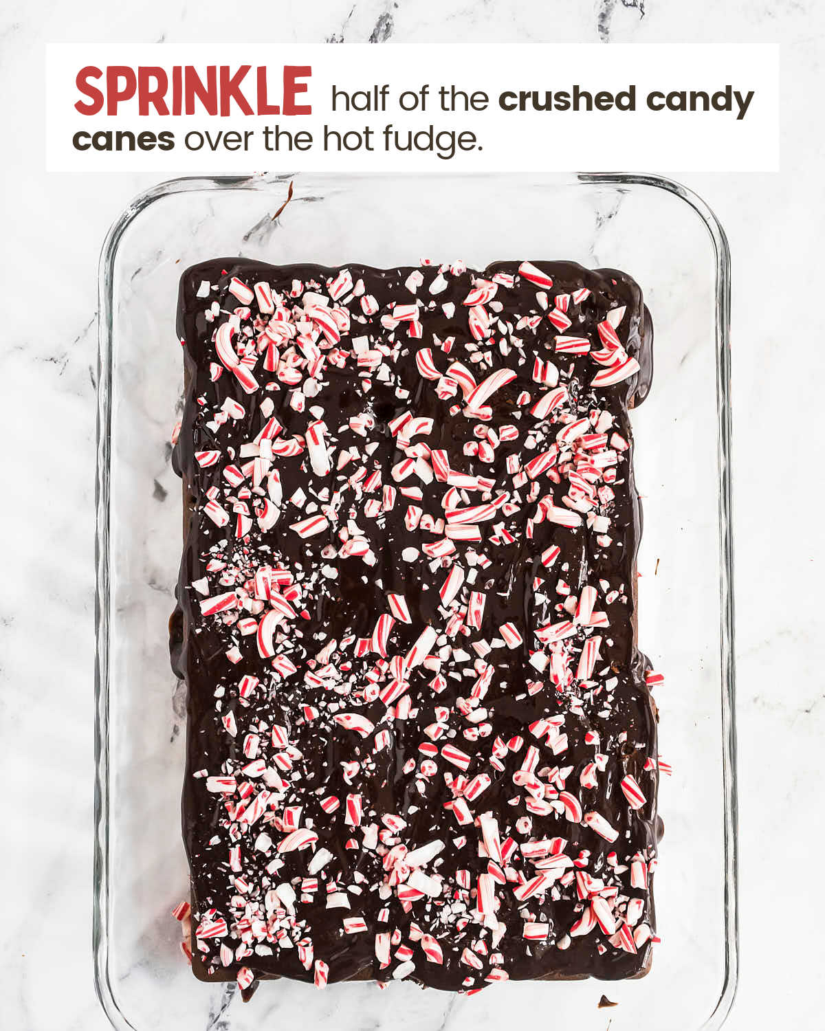 Crushed candy canes spread over hot fudge layer in a baking dish.