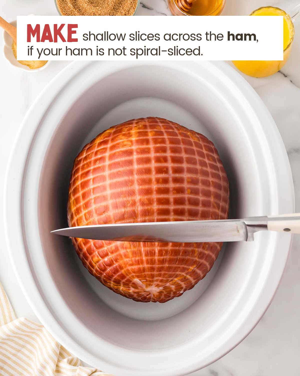 Ham in a Crockpot about to be sliced with a knife.