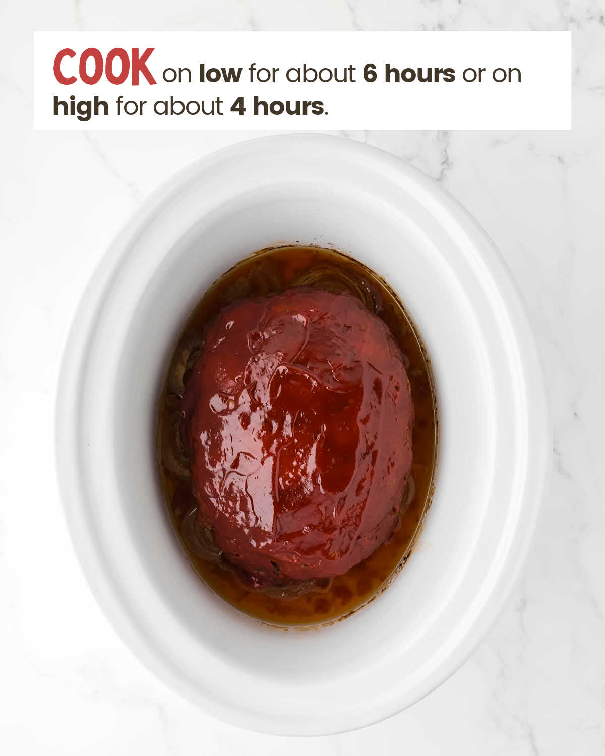 Meatloaf in a slow cooker that has finished cooking.