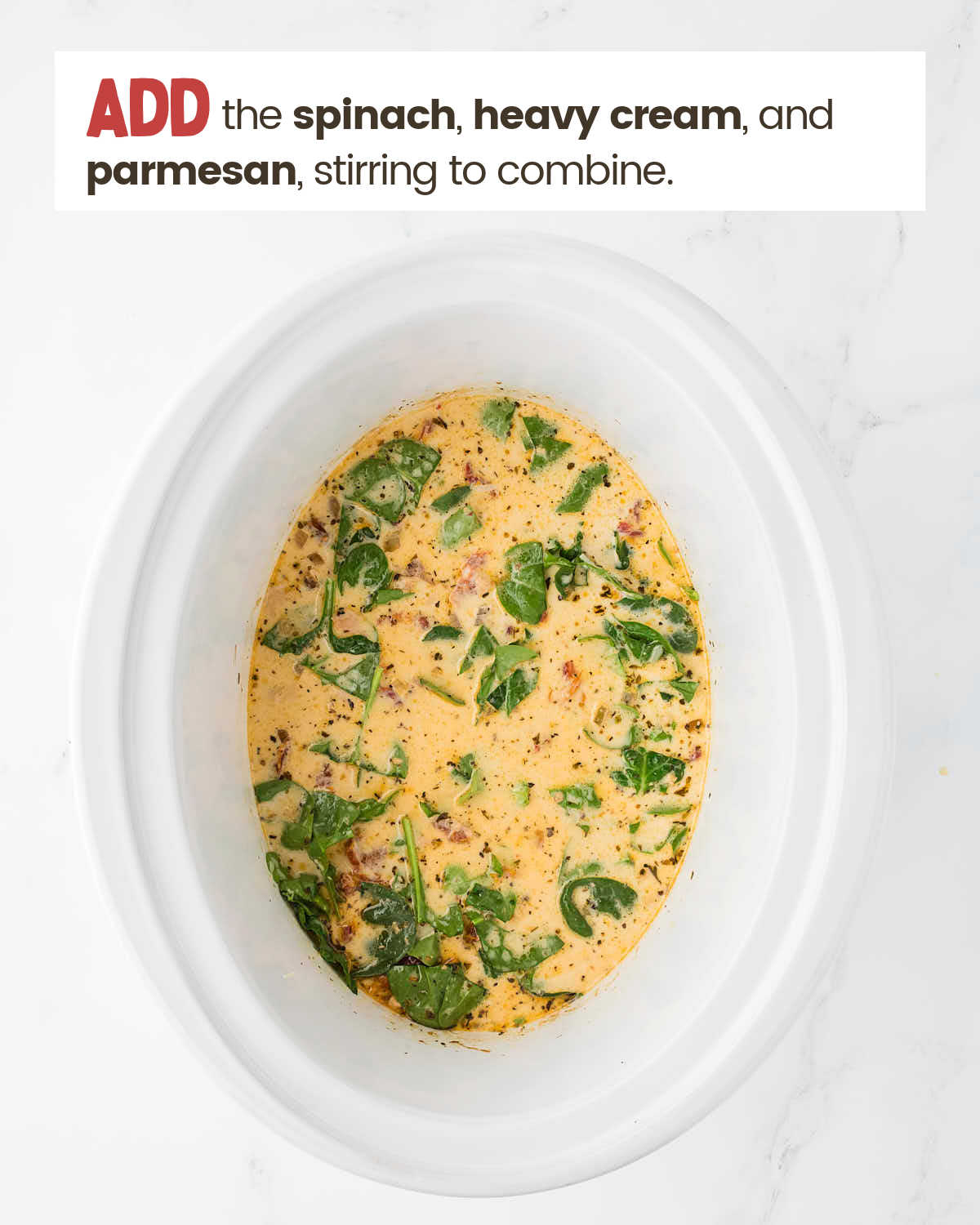 Spinach and cream mixture in a slow cooker.