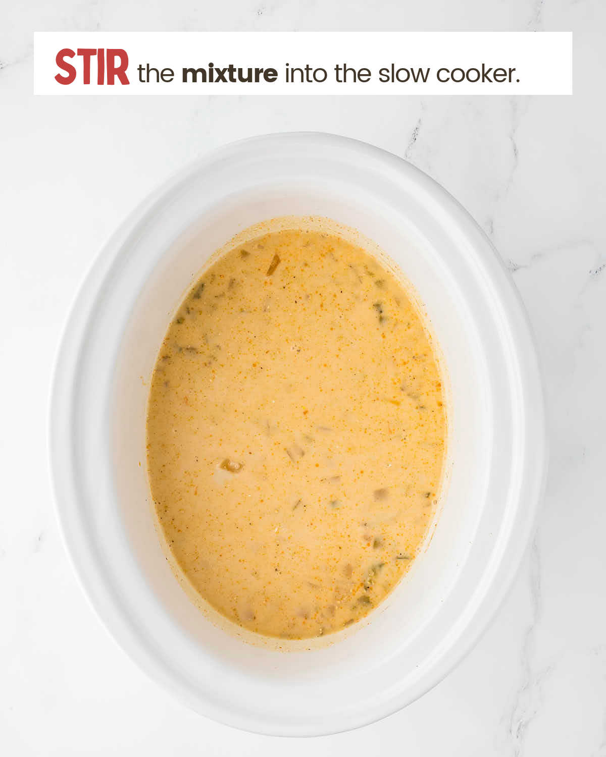 White Chicken Chili in a slow cooker with heavy cream mixture added.