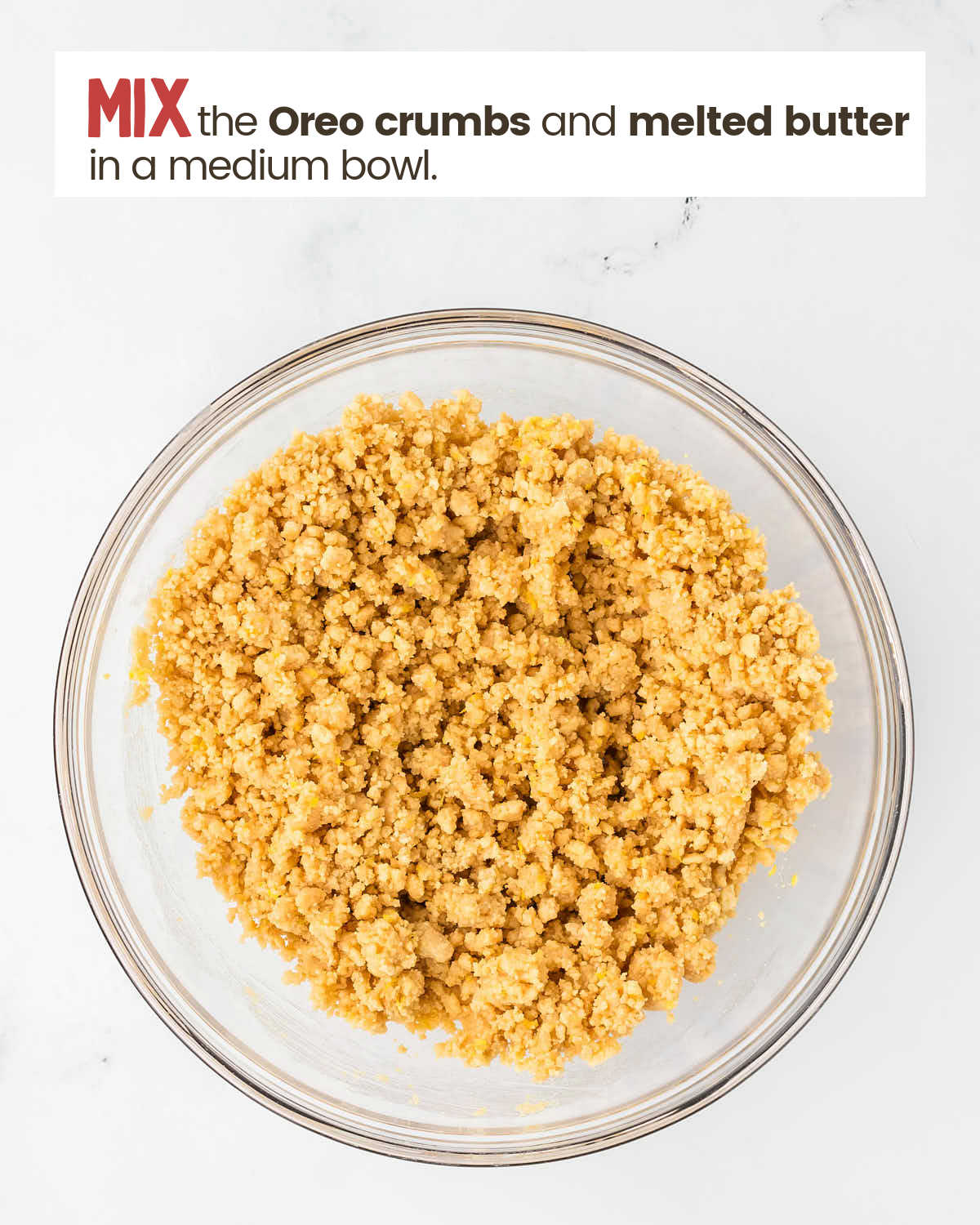 Golden Oreo crumbs and butter mixed in bowl.