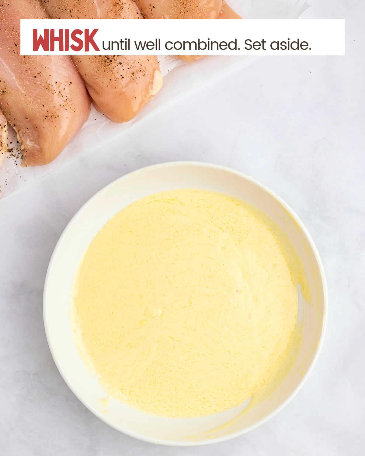 Whisked butter, garlic, and mayonnaise in a bowl.