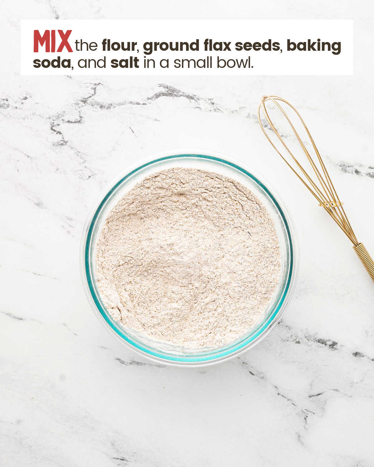 Flour mixture in a bowl with a whisk next to it.