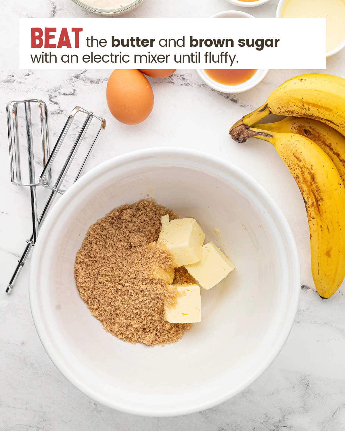 Beaters and bananas next to a bowl with brown sugar and sliced butter.