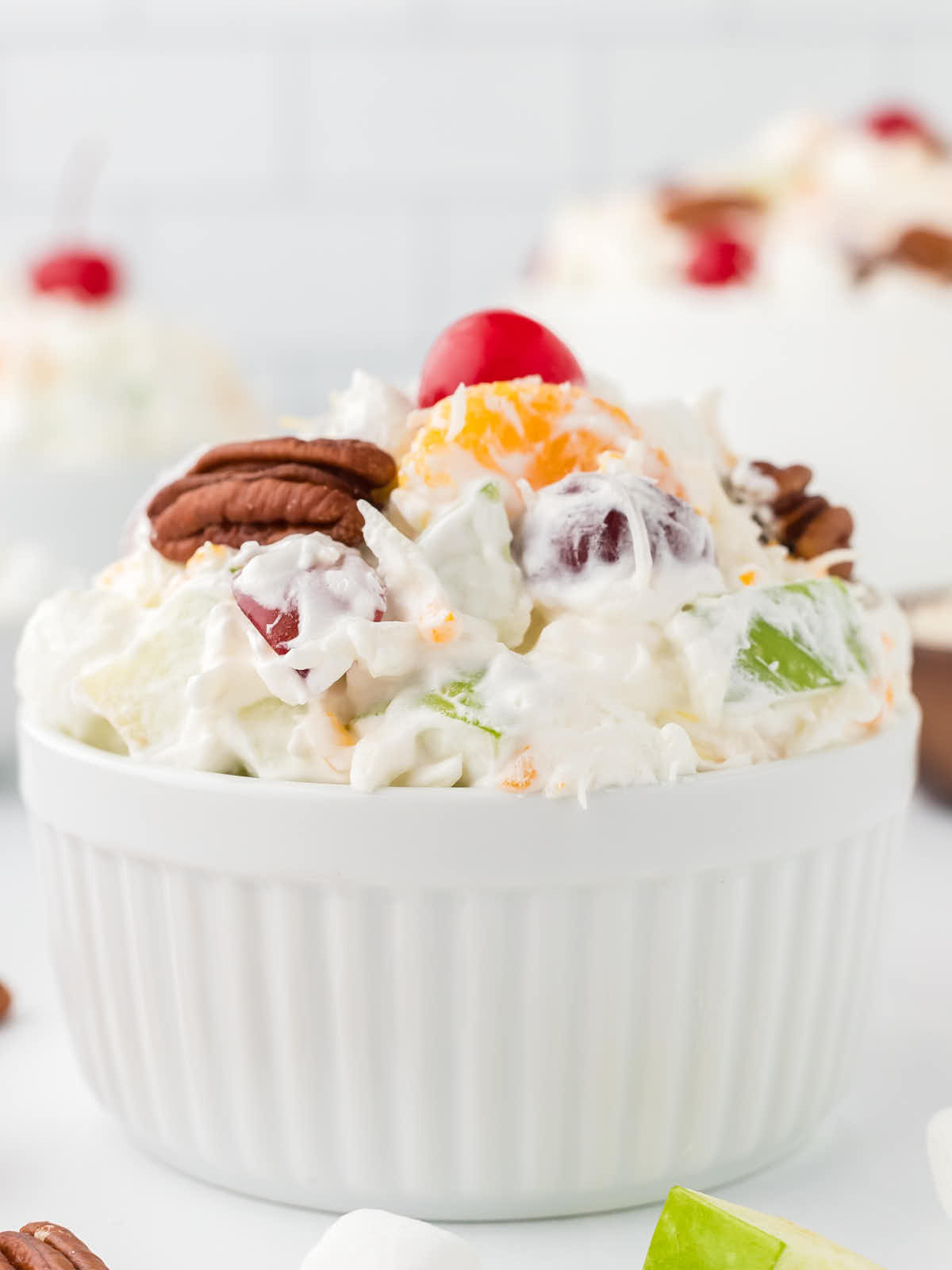 A serving of Ambrosia Salad in a white bowl.