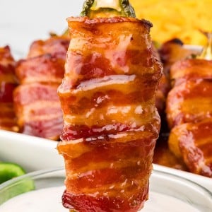 Dipping a Bacon Wrapped Jalapeno Poppers.