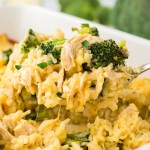 Lifting a portion of Chicken Broccoli Rice Casserole out of the casserole dish.