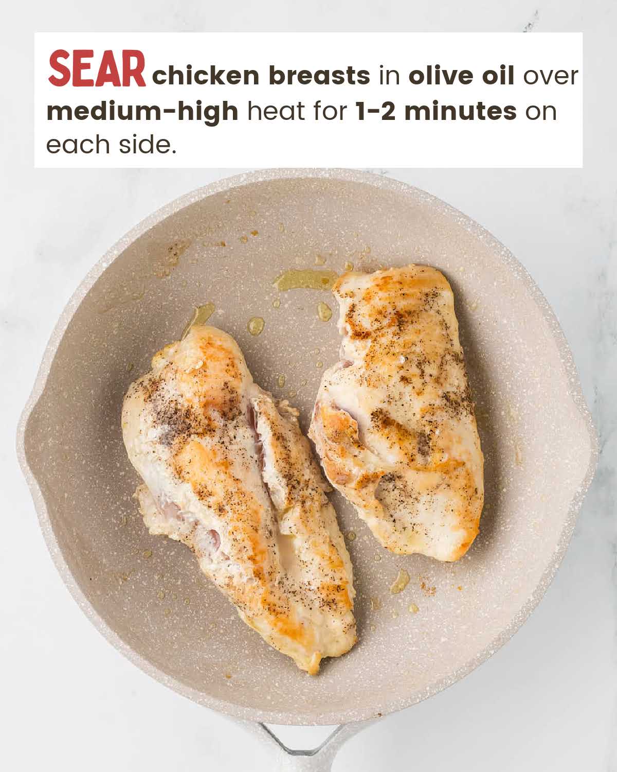 Seared chicken breasts in a skillet.