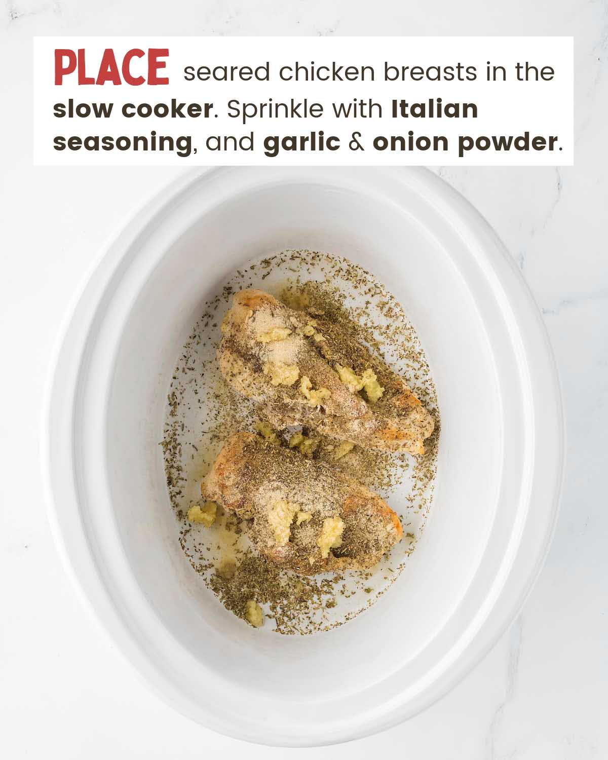 Seasoned chicken breasts in a slow cooker.