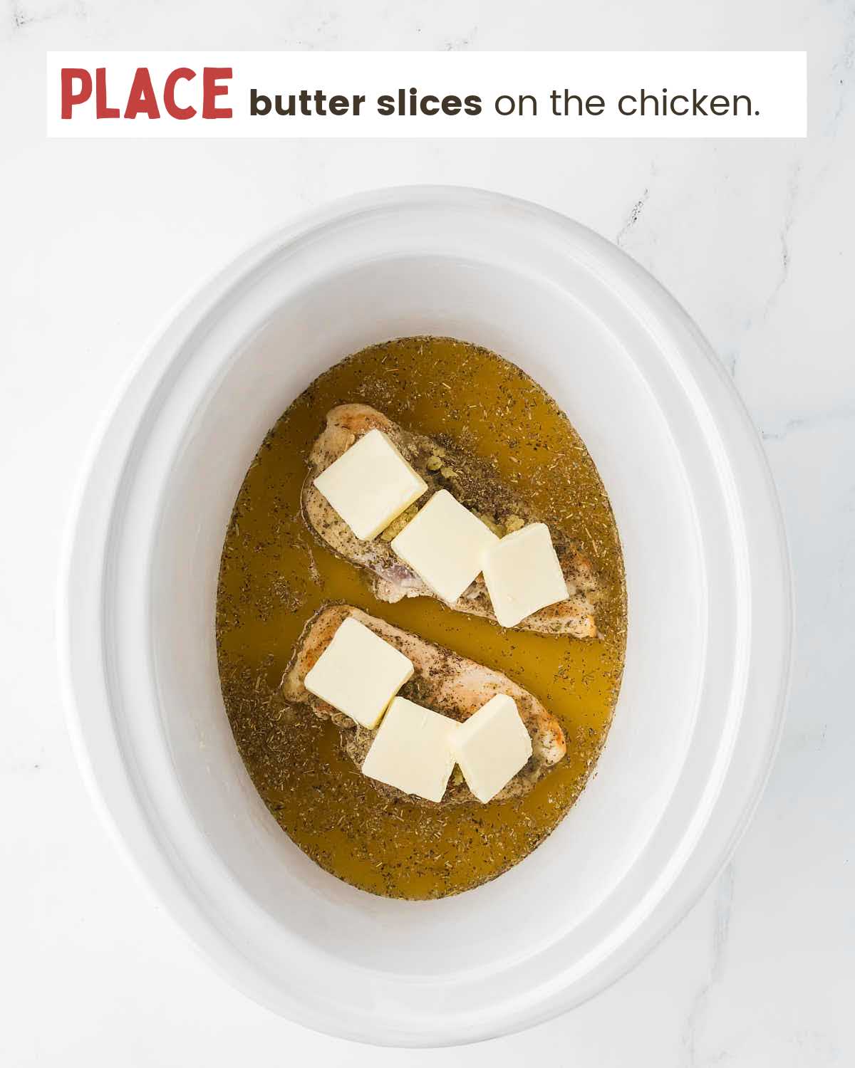 Butter slices on top of chicken in a slow cooker.