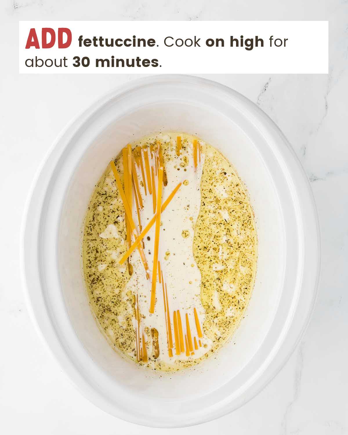 Cream sauce with dry fettuccine noodles in a slow cooker.