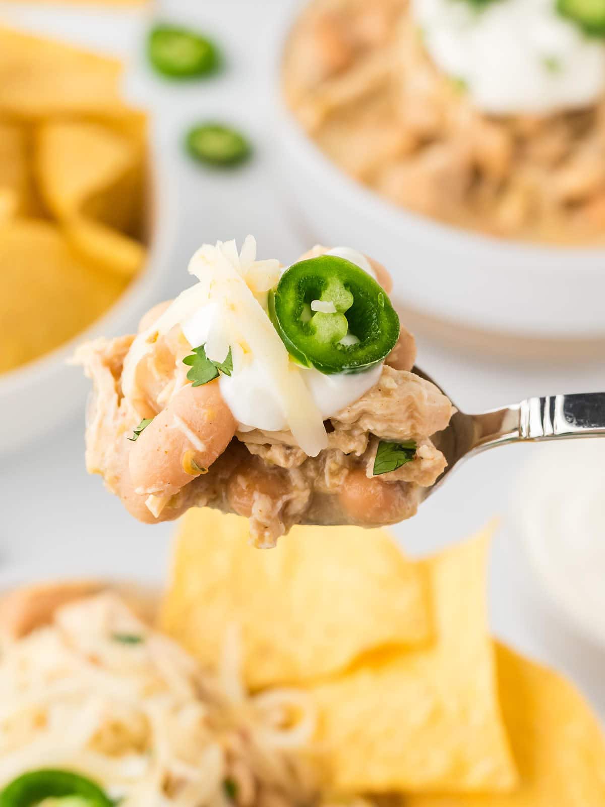 Closeup of a spoonful of Crockpot White Chicken Chili.