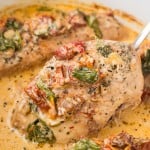 Transferring a Tuscan Chicken breast out of the Crockpot.