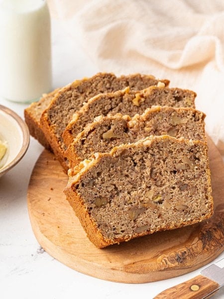Slices of Sourdough Banana Bread on wooden serving plate.