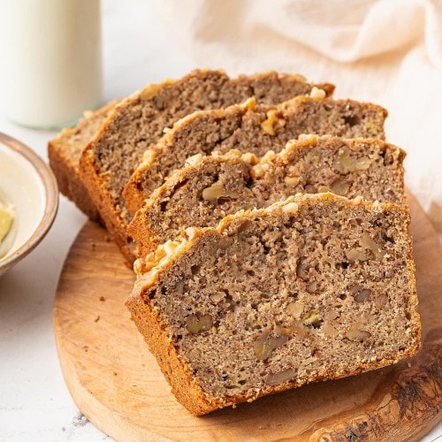 Slices of Sourdough Banana Bread on wooden serving plate.