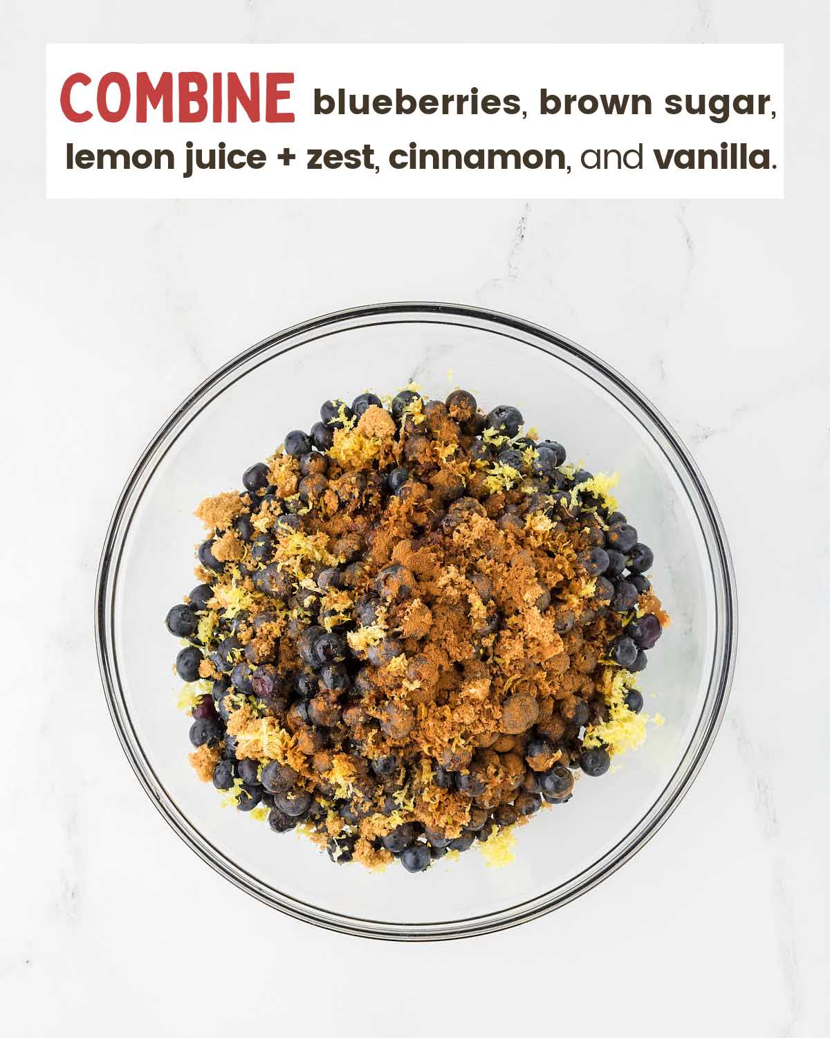 Blueberries mixed with lemon juice and spices in a bowl.