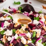 Dripping dressing over a Beet Salad.
