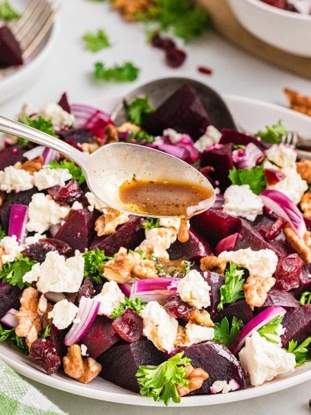 Dripping dressing over a Beet Salad.