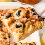 Lifting a slice of Bread Pudding out of a baking dish.