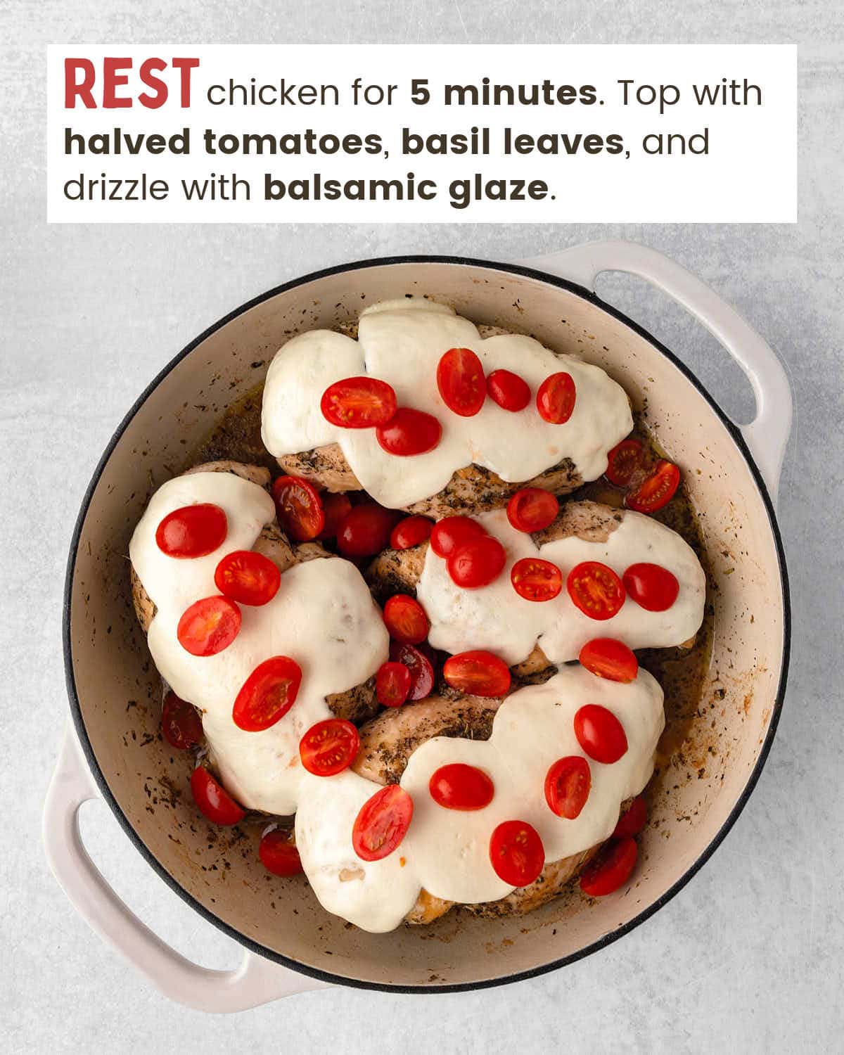 Seared chicken breasts topped with melted mozzarella slices and halved cherry tomatoes in a skillet.