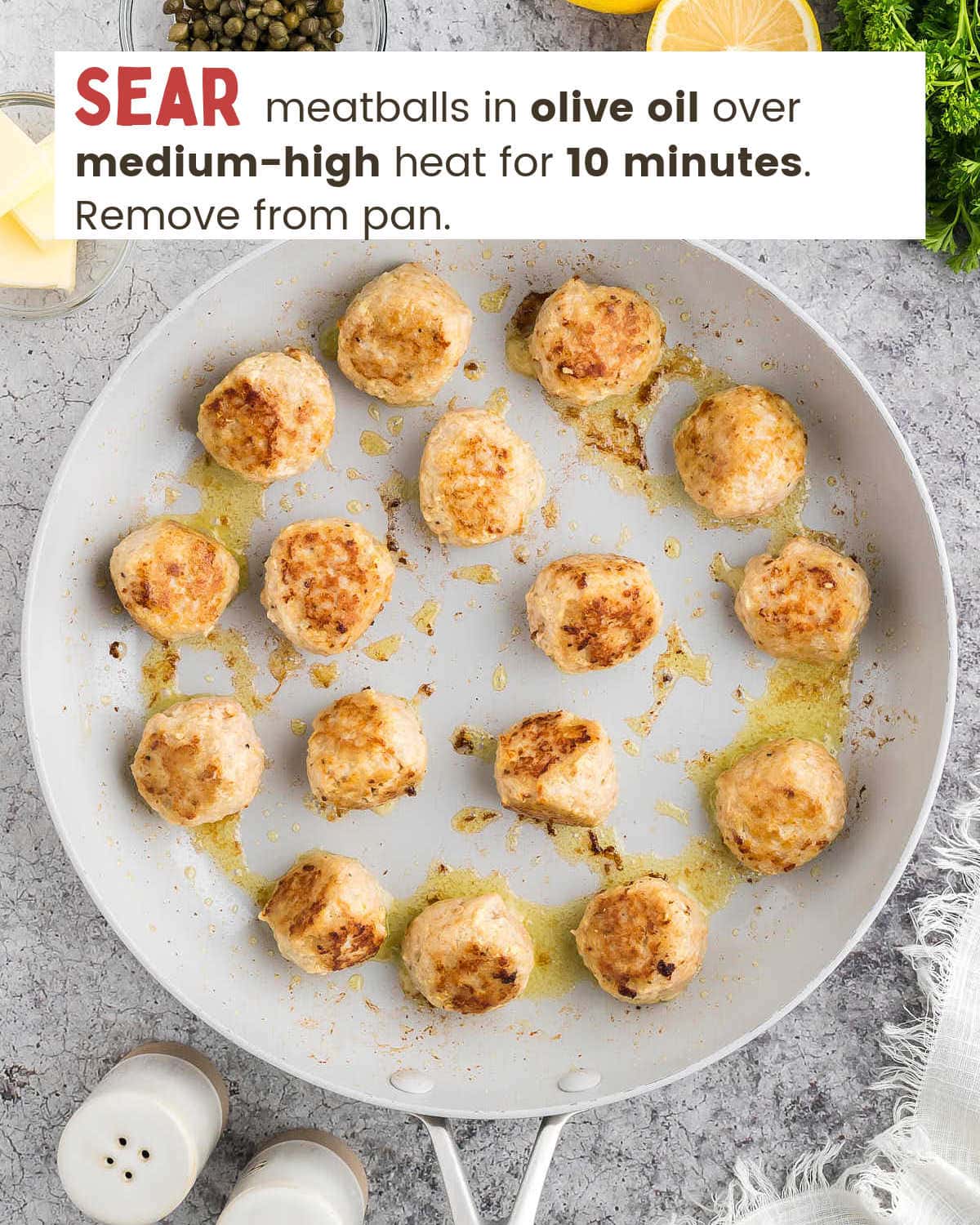 Chicken piccata meatballs in a skillet.