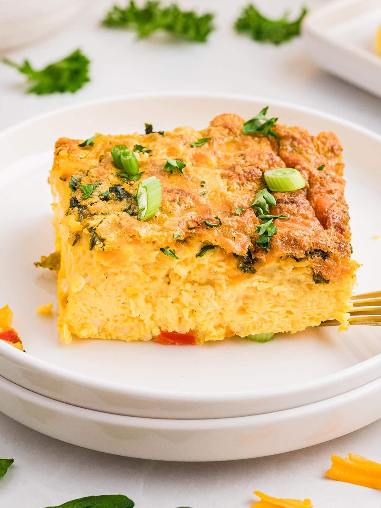 A slice of Cottage Cheese Egg Bake on a white plate.