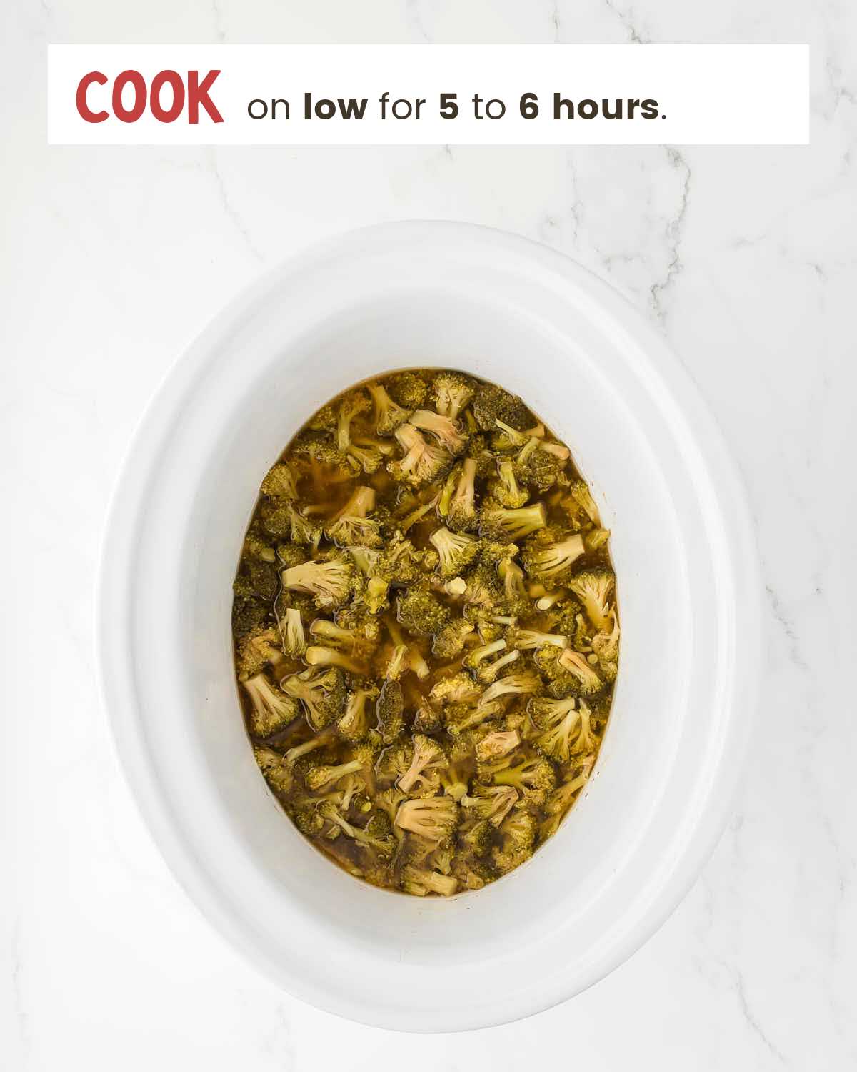 Broccoli cooked in broth in a slower cooker.