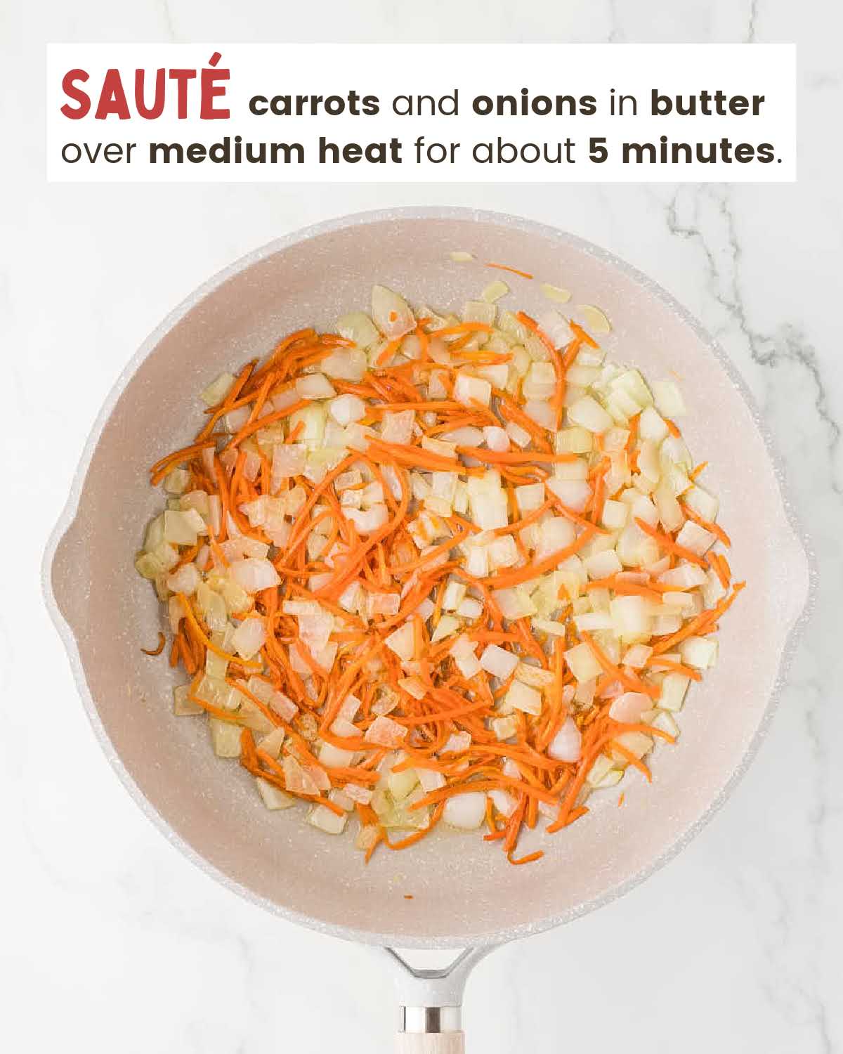Carrots and chopped onions sautéing in a skillet.
