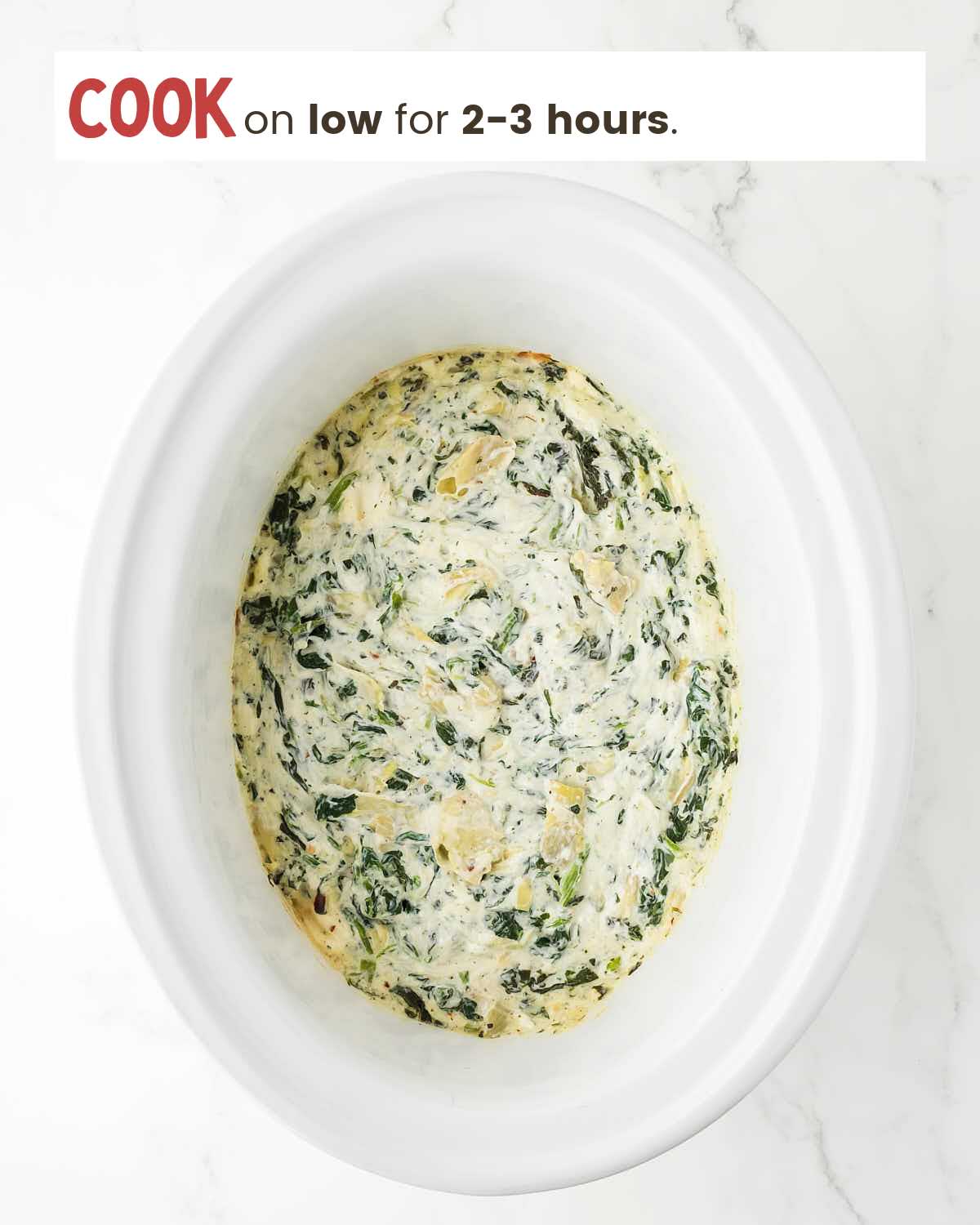 Spinach artichoke dip in a slow cooker.