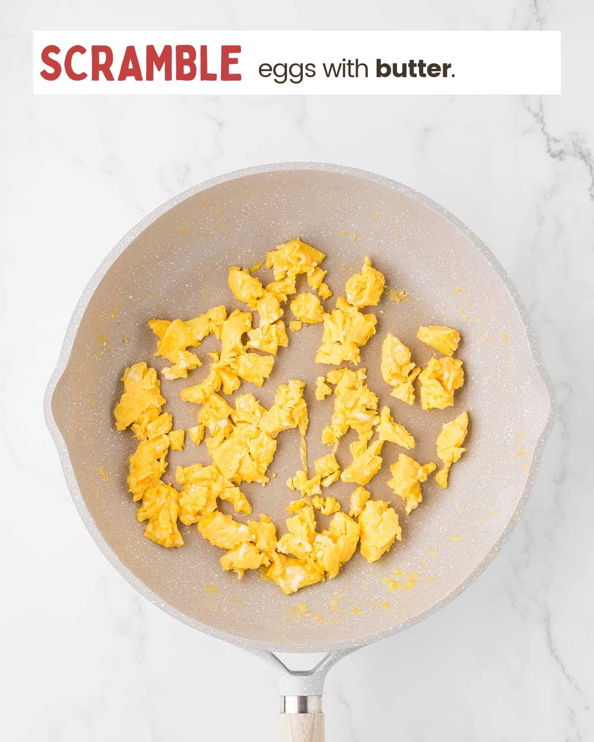 Scrambled eggs in a pan.