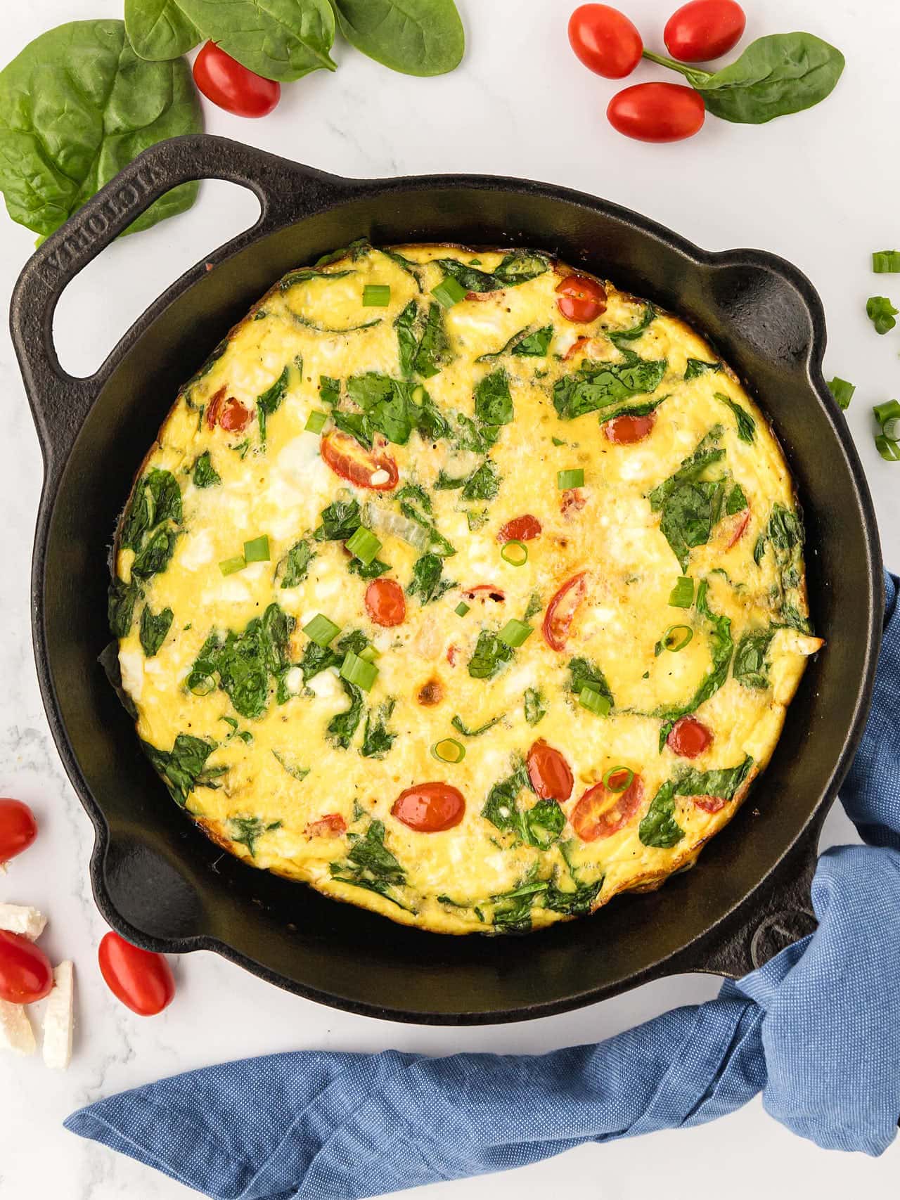 Topdown view of a Frittata in a cast iron skillet.