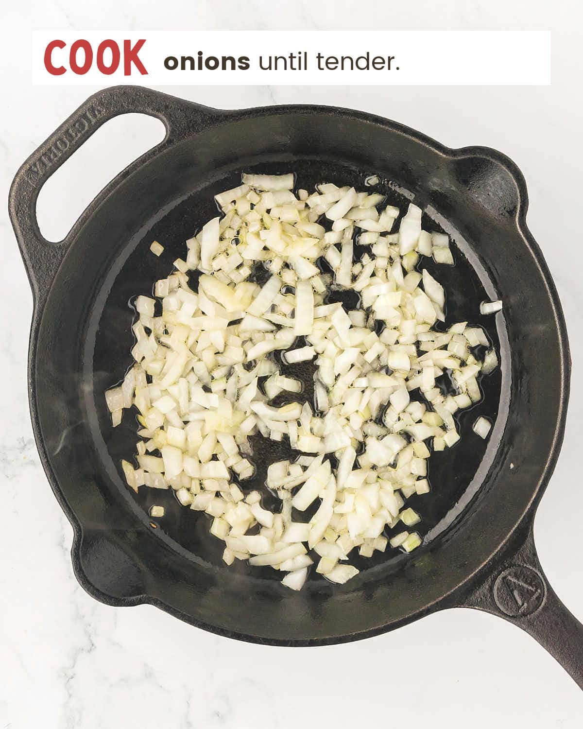 Chopped onions in a cast iron pan.