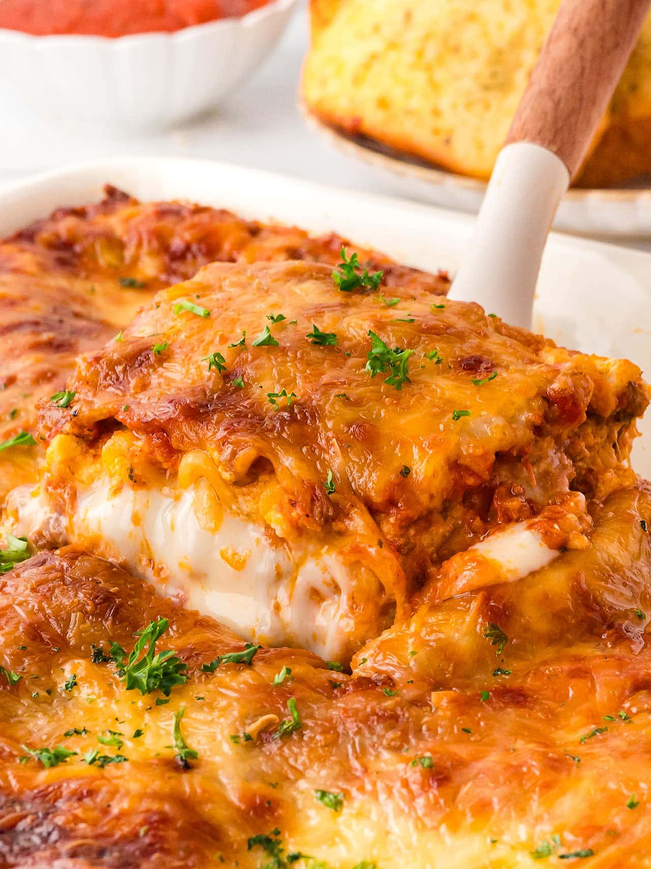 Lifting a slice of homemade Lasagna.
