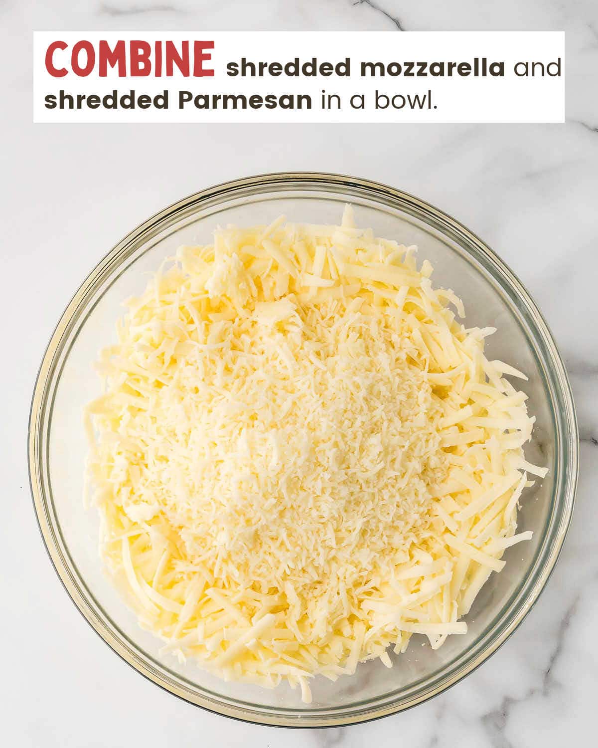 Shredded mozzarella and Parmesan cheeses in a bowl.