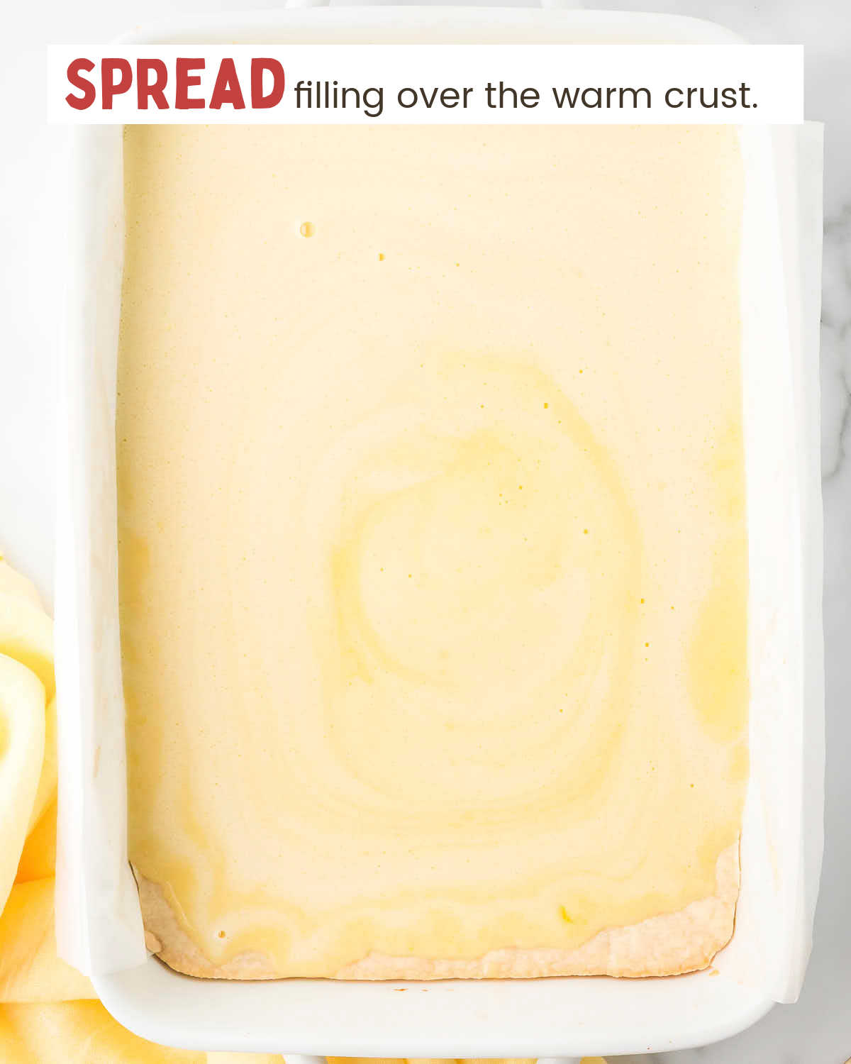 Lemon filling over a crust in a baking dish.