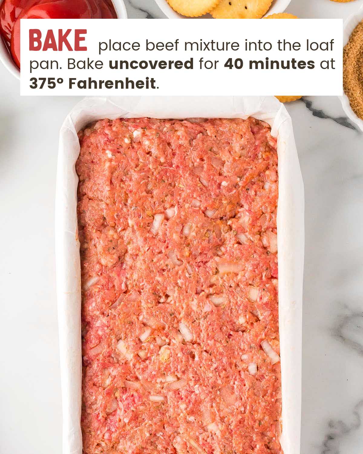 Raw meatloaf in a parchment lined loaf pan.