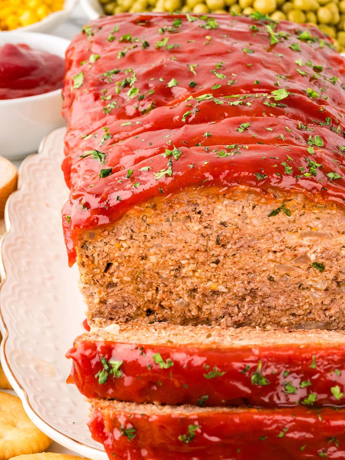 Closeup of a sliced classic homemade Meatloaf on a white plate.