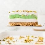 A slice of Pistachio Lush on a serving spatula.