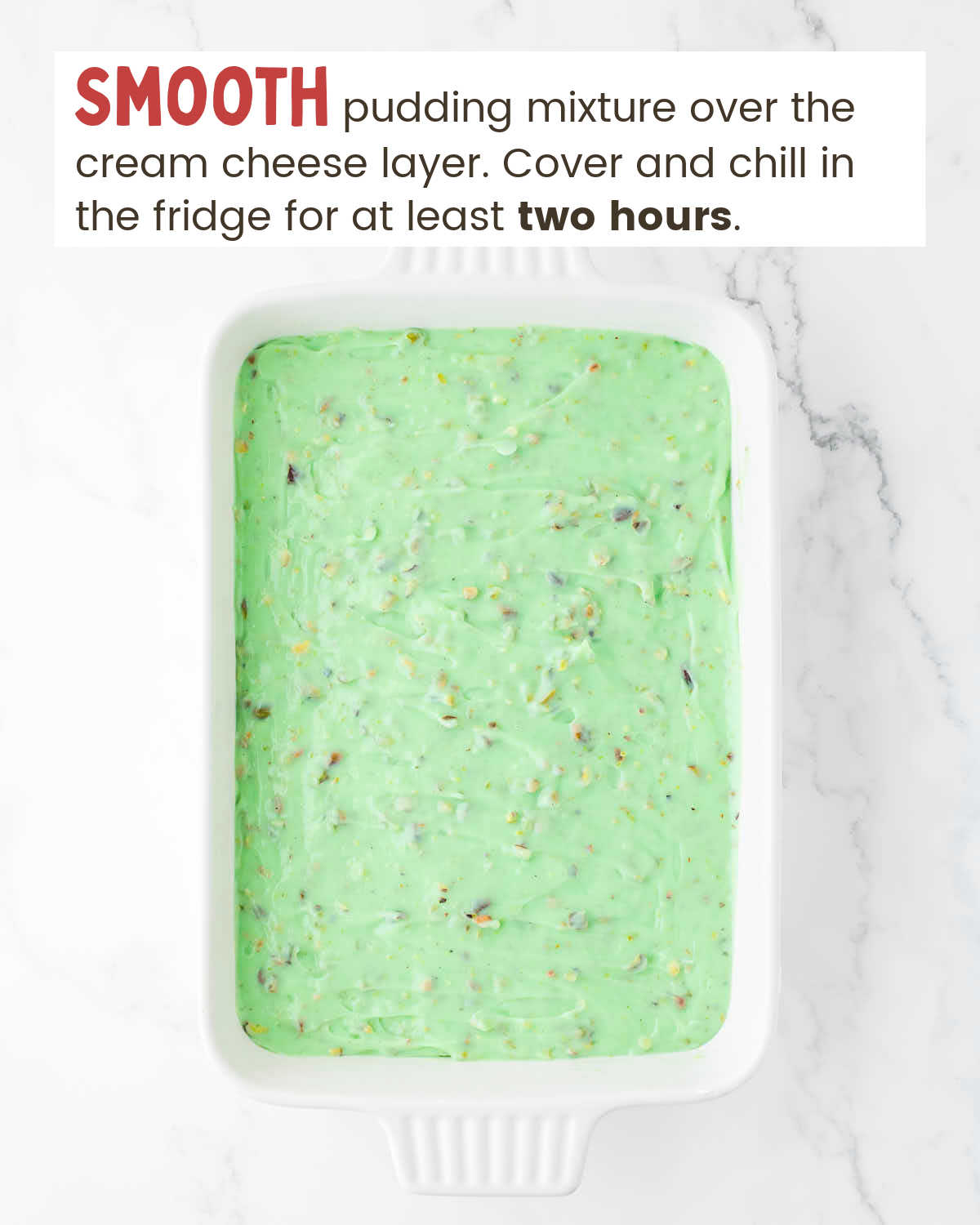 Pistachio pudding mixture layer in a baking dish.
