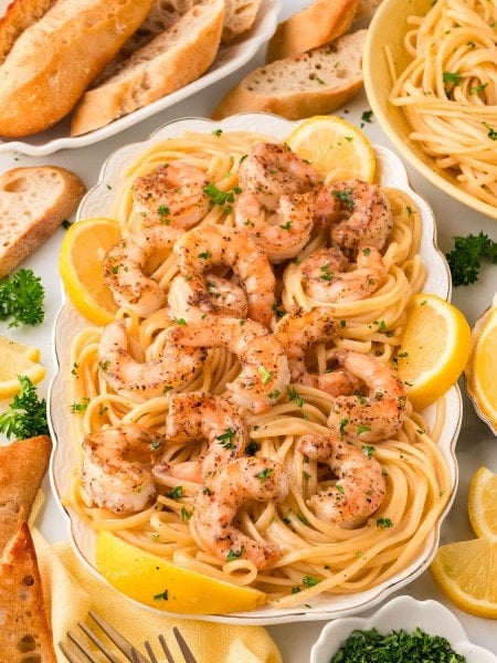 Shrimp Scampi served family style over spaghetti.