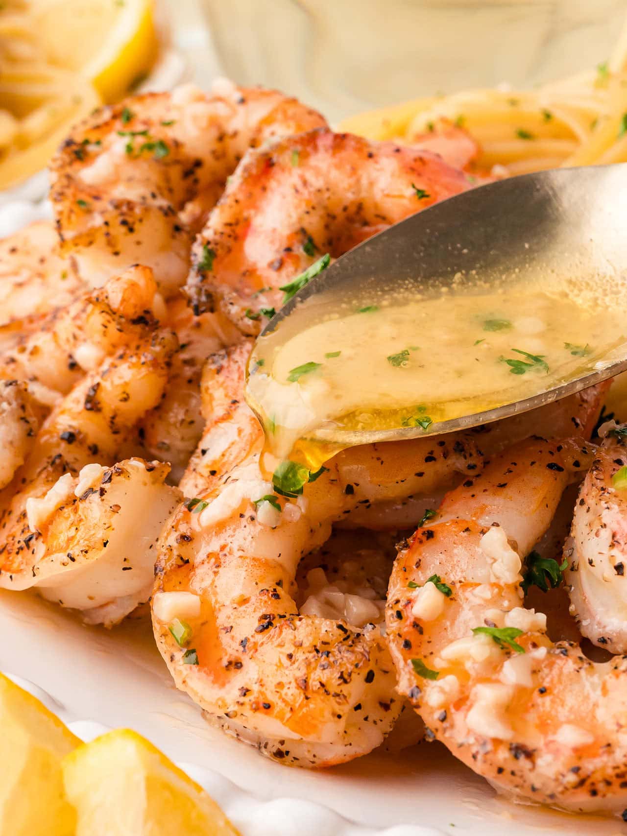 Pouring sauce over the Shrimp Scampi.