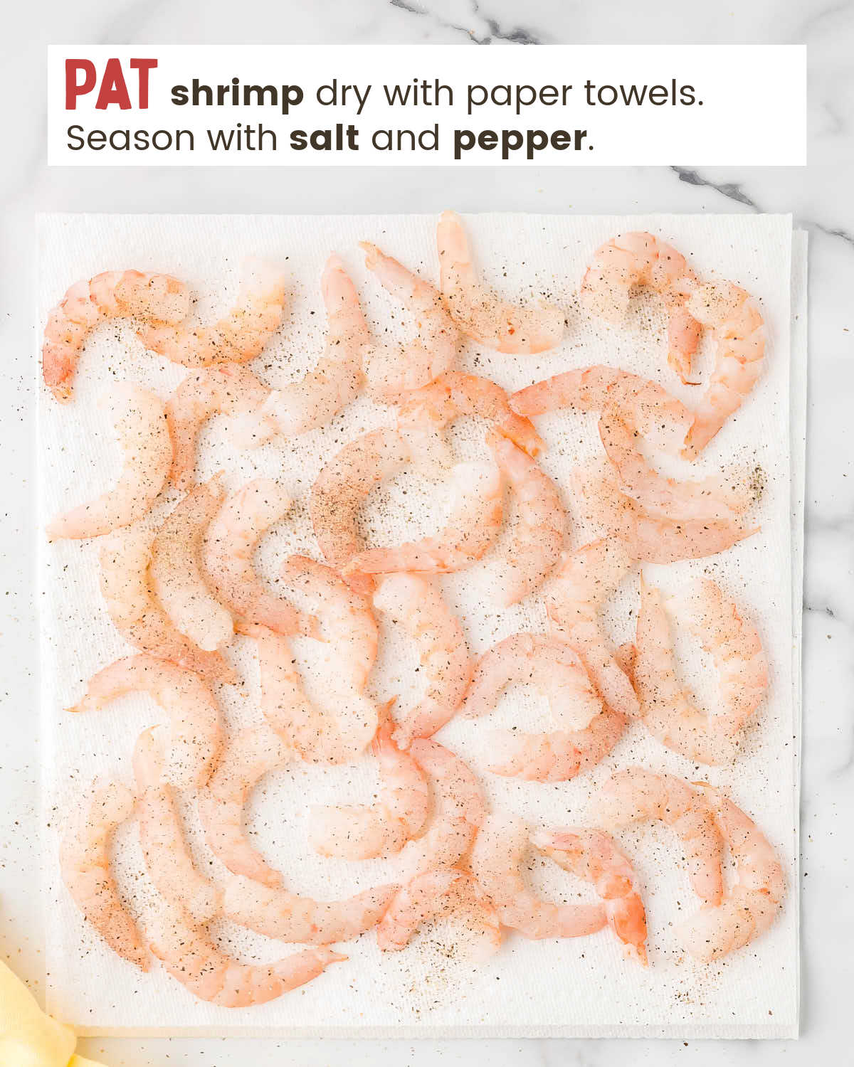 Raw shrimp on paper towels seasoned with salt and pepper. 