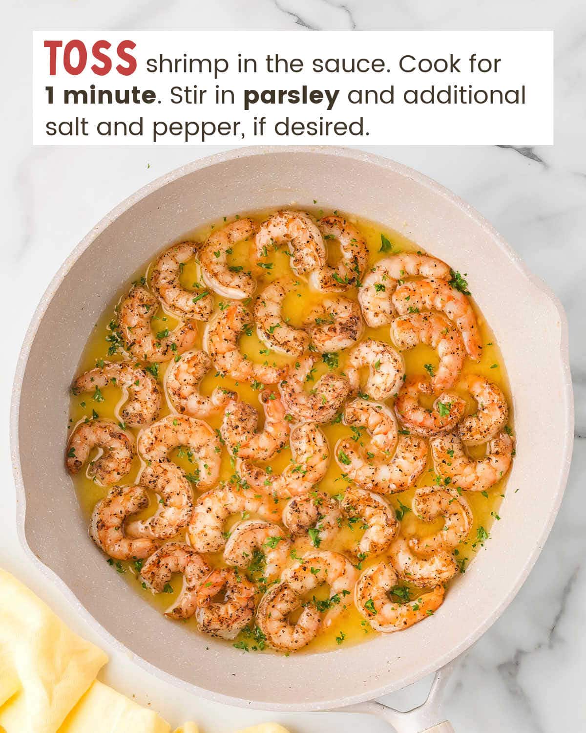 Shrimp scampi with parsley in a skillet.