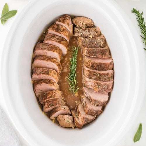 Top down view of a cooked Pork Tenderloin in a slow cooker.