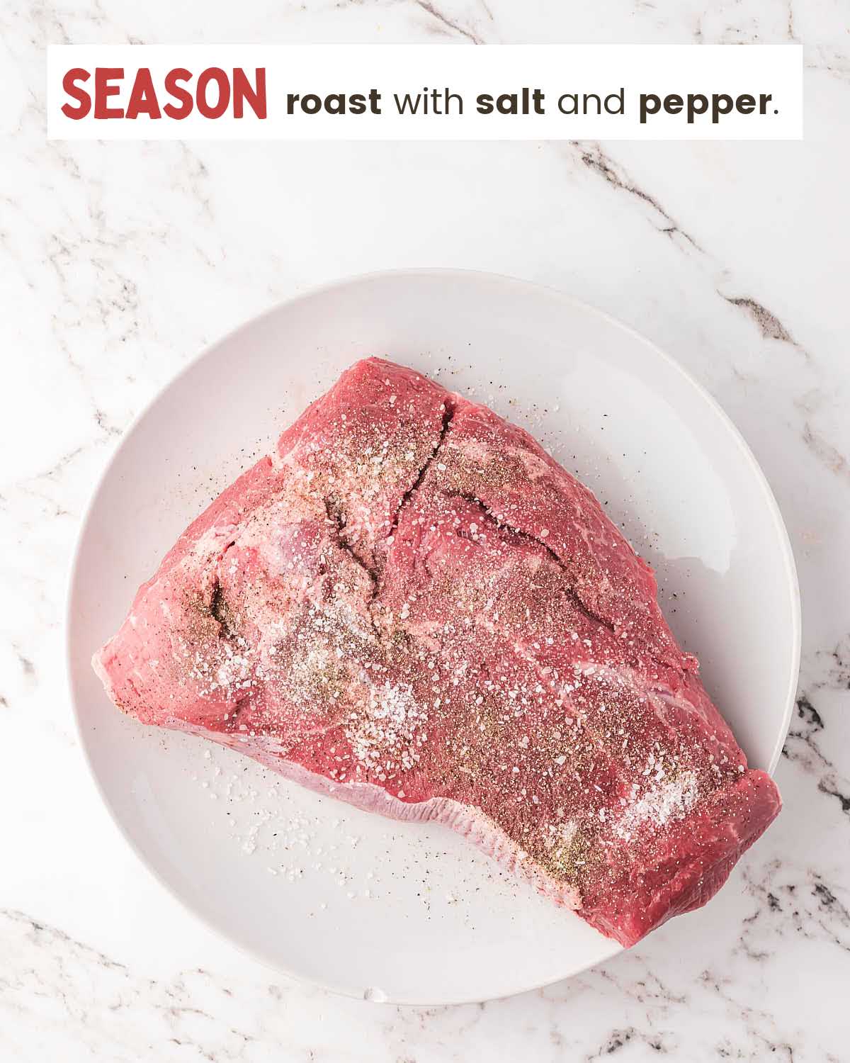 Chuck roast seasoned with salt and pepper on a white plate.