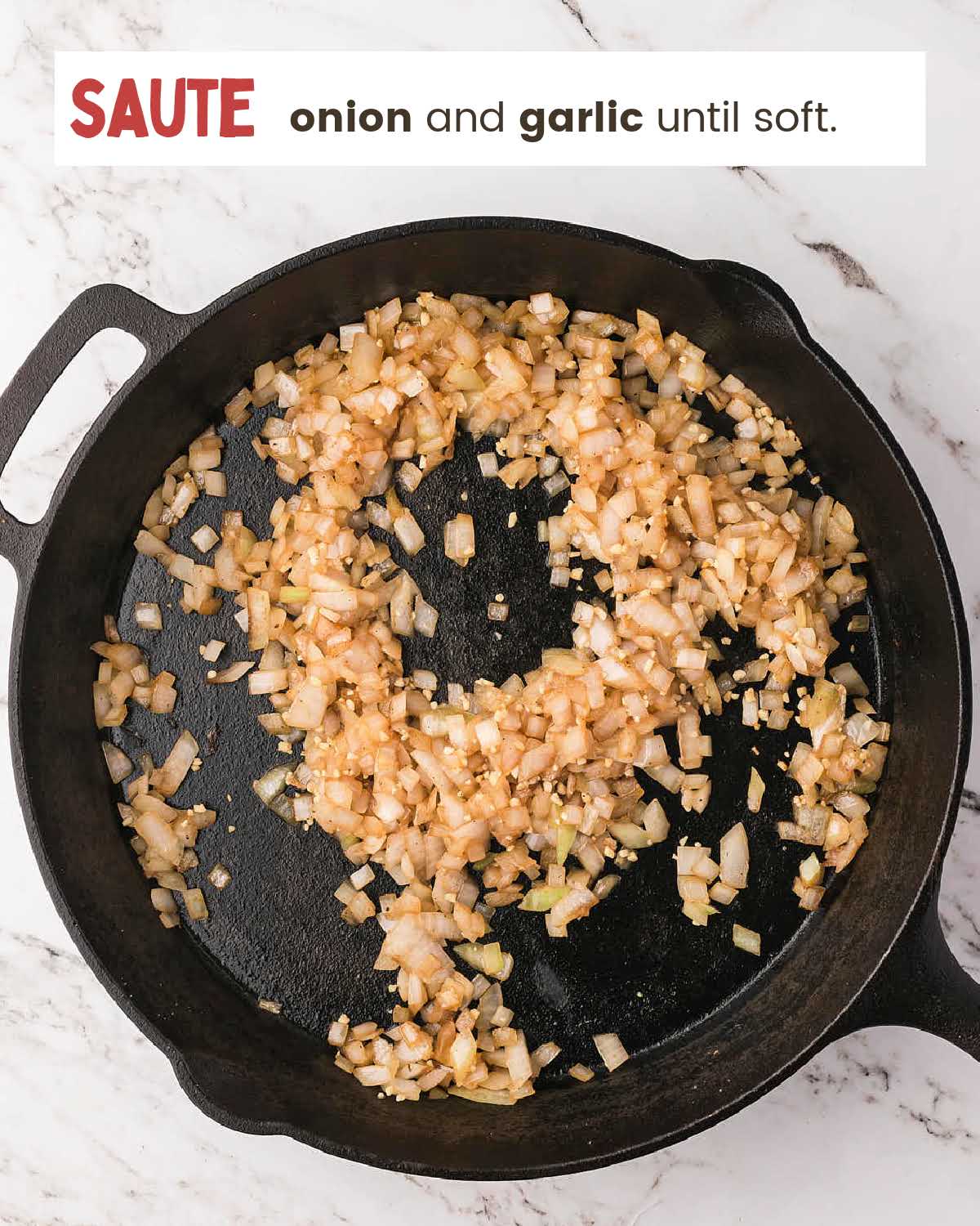 Sautéed onion and garlic in a cast iron skillet for slow cooker pot roast.
