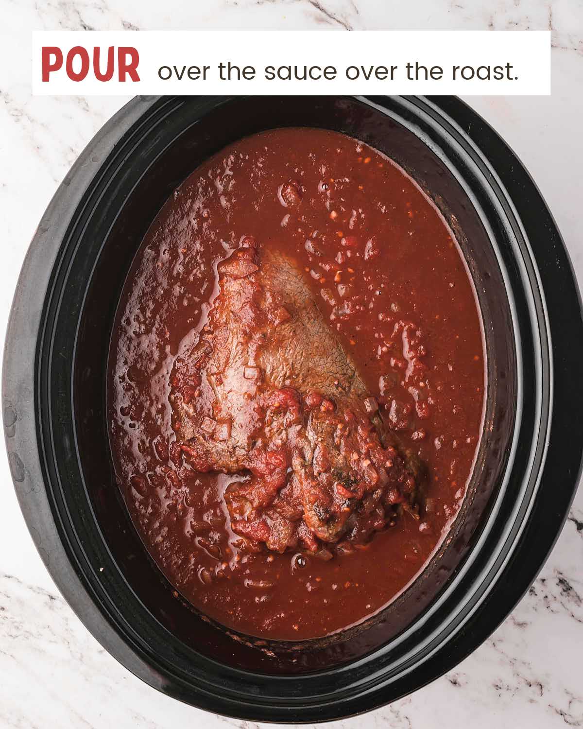 Pouring tomato sauce over a seared chuck roast in a slow cooker.