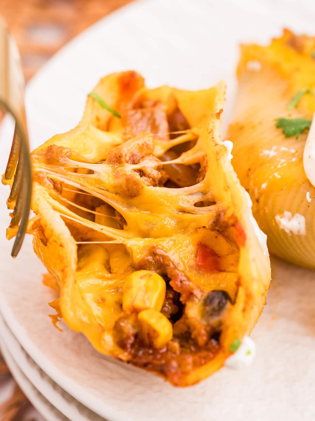 Closeup of a cheesy Taco Stuffed Shell.
